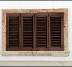 Finestra di una villa a mare con rivestimento in pietra